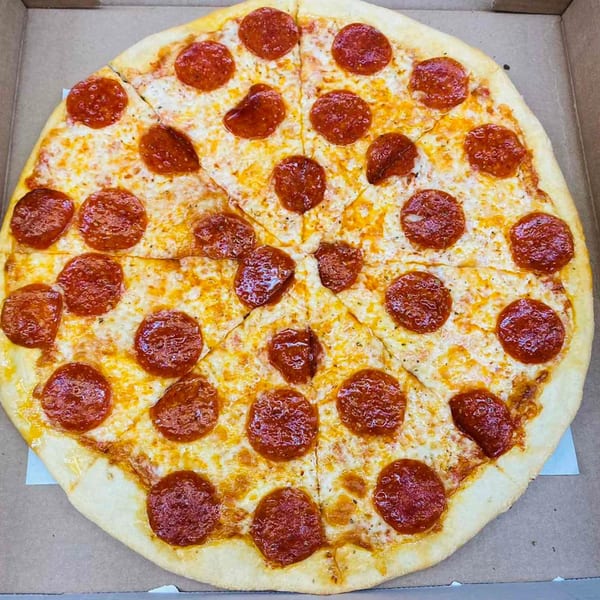 A whole Pascali's Pizza Corner pepperoni pizza, cut into slices, in a cardboard box.